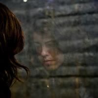 Reflection of a woman looking at the floor