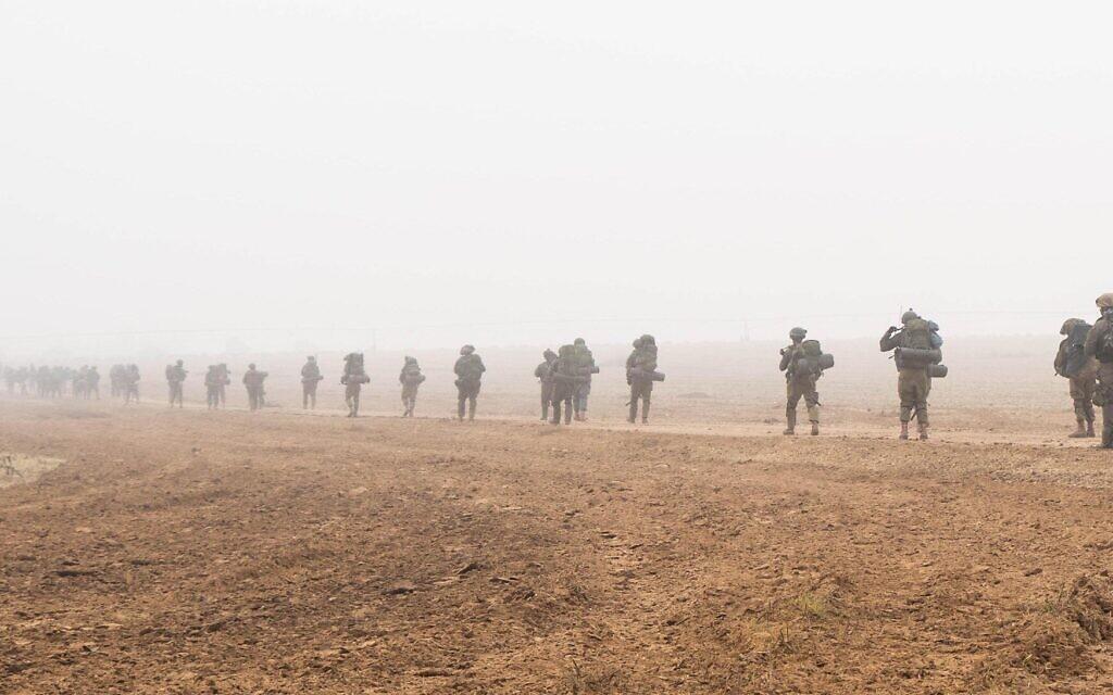 Israeli troops march in single file in fog in Gaza IDF photo