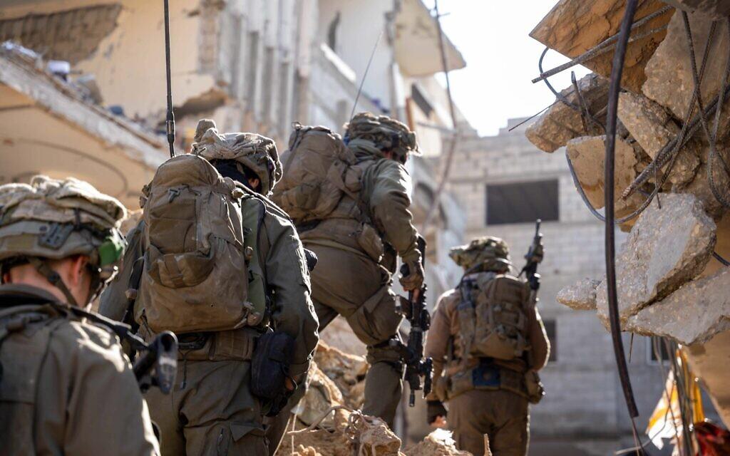 Israeli troops advance through rubble IDF photo